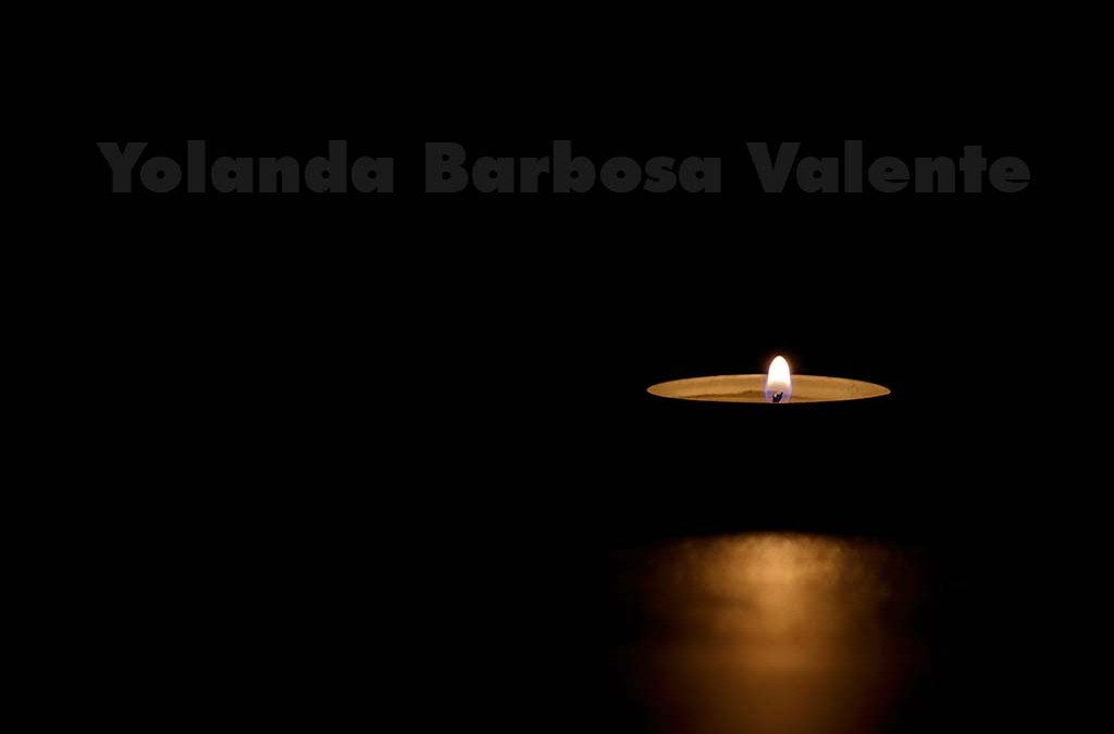 A lit tin candle in the dark conveying memorial, death, hope or darkness